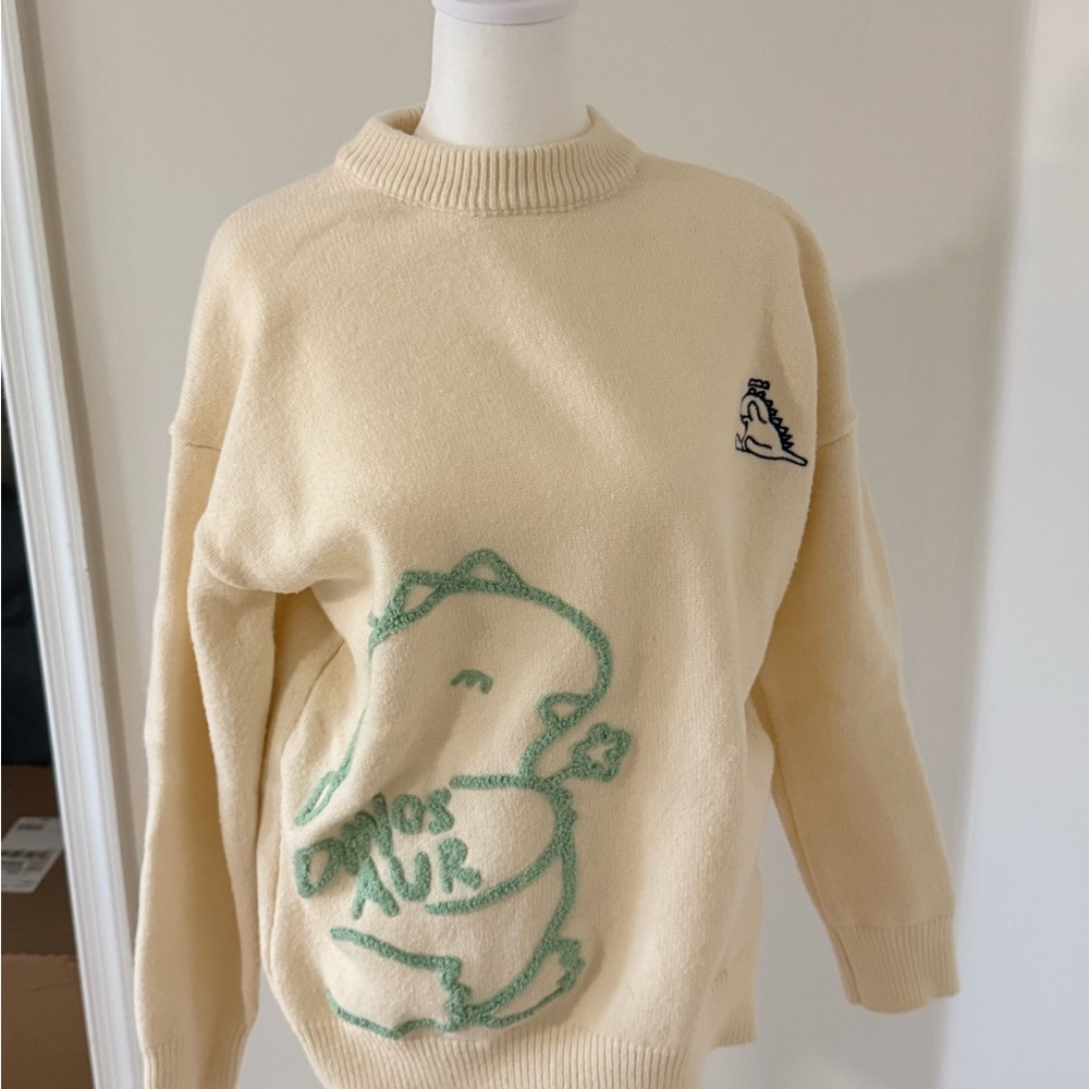 Cider Cream Sweater with Green Dinosaur Design